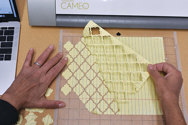 1 Prep and peel the freshly cut Moroccan tile-shaped stencils for the resist process.