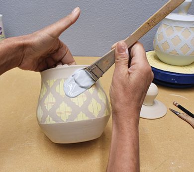 4 Use a brush to apply Mayco Stroke and Coat glaze on the exterior of the pot.