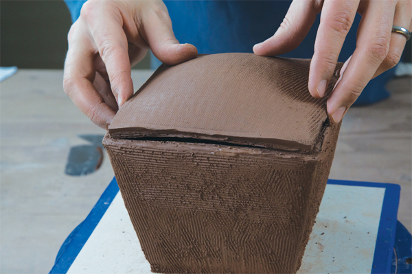 6. After the lid has slumped slightly in the box and firmed up enough to hold its shape, flip it over and attach it to the box form.