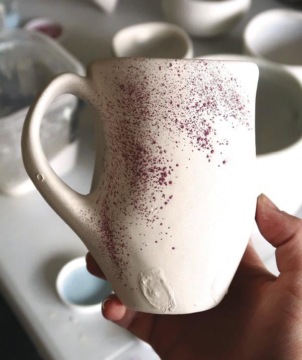 1 Once the piece is glazed with a liner and base glaze, sprinkle cobalt oxide to produce specks of blue.