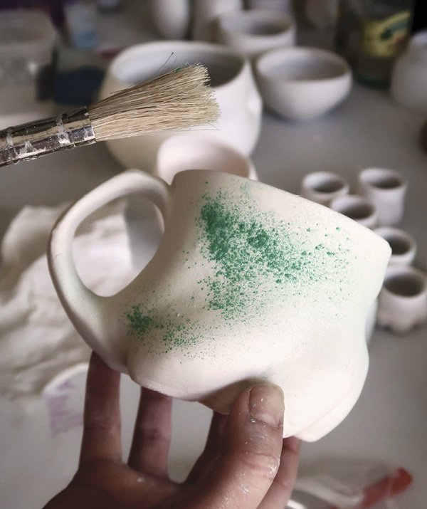 2 Use a paint brush to sprinkle copper carbonate on the surface to produce specks of red.