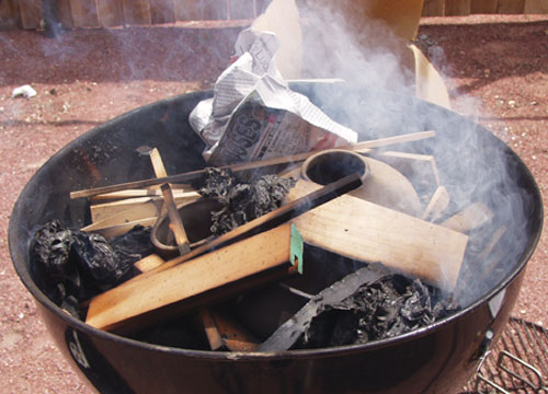 Fig.3 Surround taller pots with wood scraps. Use newspaper to encourage the wood to burn.