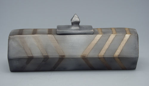 Fig.10 A white stoneware lidded box with masking tape resist decoration after a smoke firing in a Weber grill.