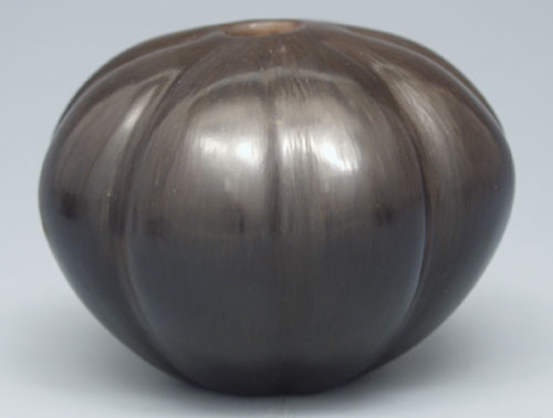 Fig.13 A red stoneware, stone burnished pot, bisque-fired to cone 018, placed inside a perforated coffee can and fired in a Weber grill.