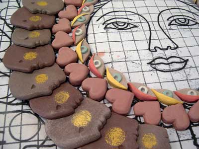 Students were divided into groups, some taking on mass production tasks, rough cutting multiple forms like the hands, faces, eyes and hearts shown above.
