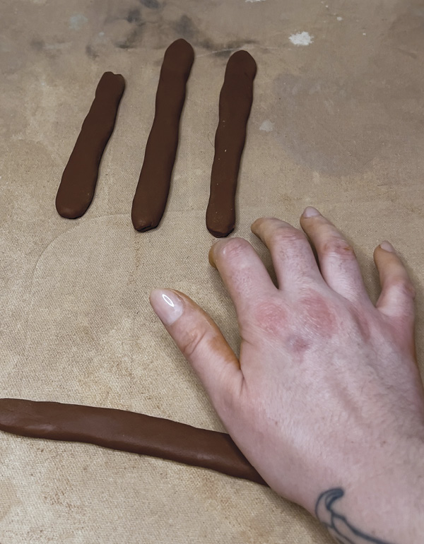 4 Roll out short coils and flatten them into strips using the heel of your hand.