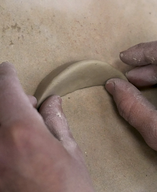 2 Pinch and shape one coil segment into a rough spout form.