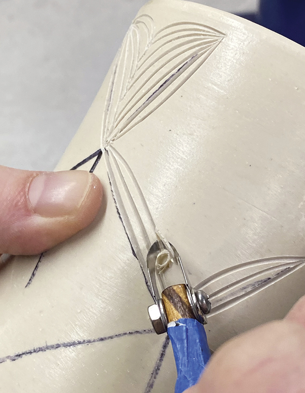 3 Using a sharp carving tool, carve through the design about 1mm deep.