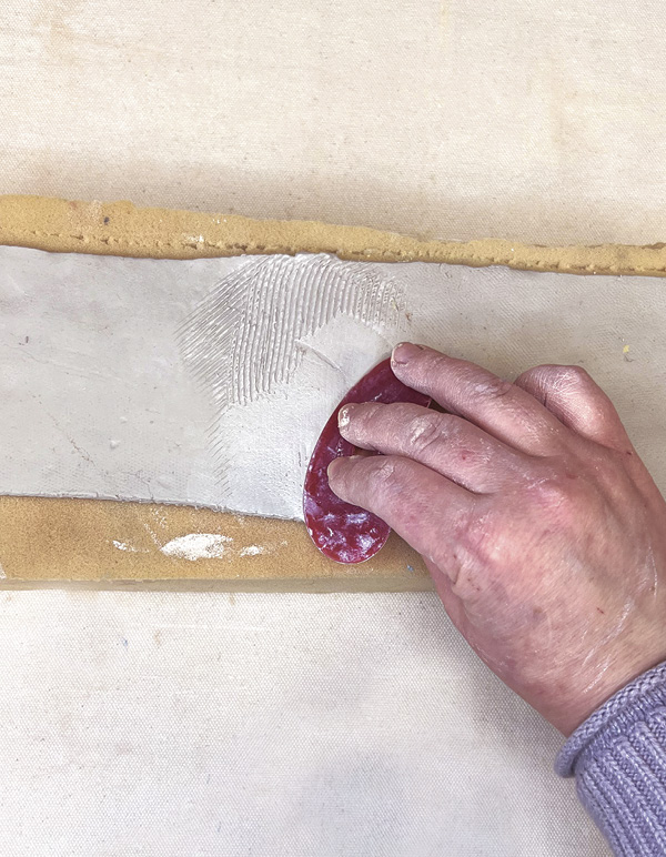 6 Flip the connected slabs over. Use a serrated rib to firmly blend the seam.