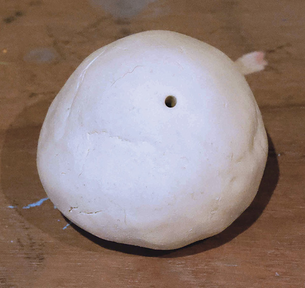 2 Join two pinch pots, then add a hole at the center.