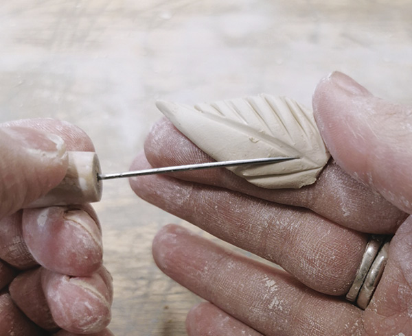 6 Carve leaf shapes and refine them with a needle tool.