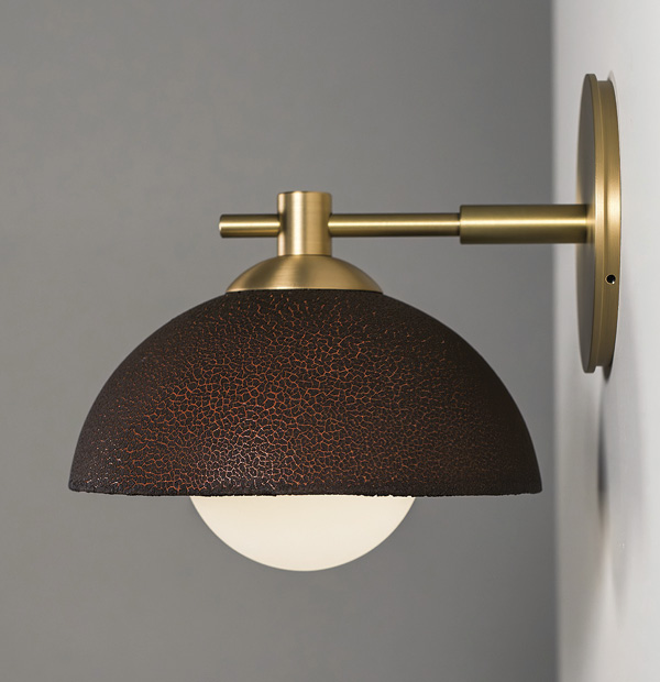 8 Pax Lighting's The Dixon Sconce in brushed brass and black lichen glazed terra cotta.