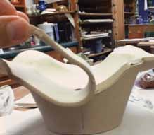 4 Place a slab over the scored base, trim it flush to the sides and attach it.