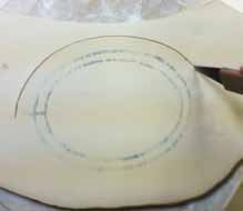 8 Cut a slightly larger oval around the lines into a lid shape and refine the edges.