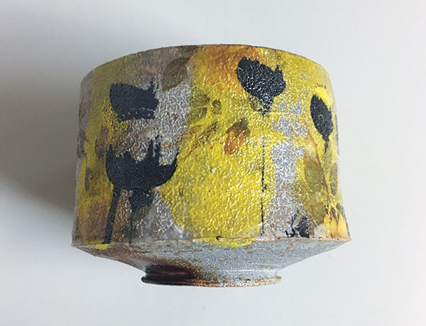 Refired bowl with decals now fired on, fresh from the kiln. Ready to have red poppy decals applied.