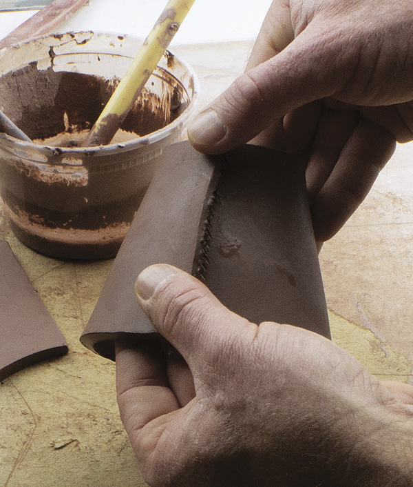 3 Bevel, score, slip, and join the walls together. Compress the seam while supporting from the inside.