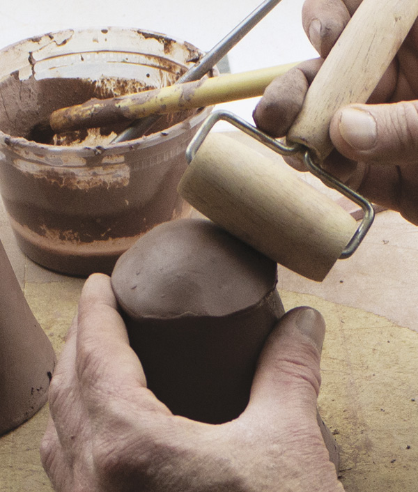 5 For the top, use a pony roller to seal and compress the seam between the slab and the wall.