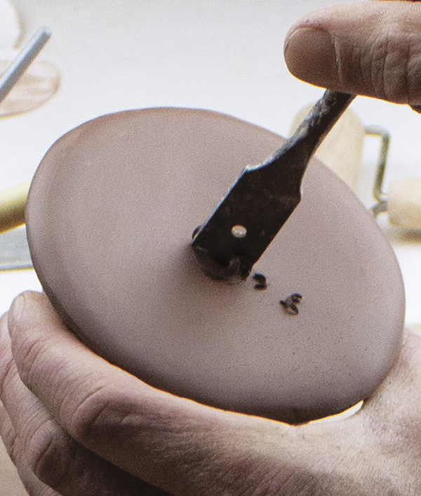 7 Use a spade drill bit to drill holes on the bottom of the shakers. Allow the shakers to dry to leather hard.