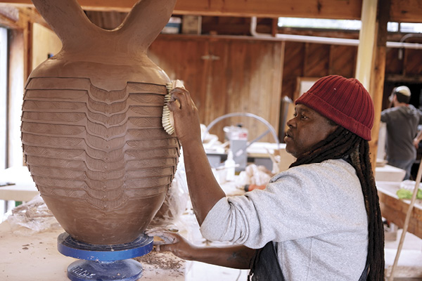 A resident artist with a work in progress during the Open Studio Residency program, 2023. Photo: Dan Rajter. Haystack Mountain School of Crafts, Deer Isle, Maine.
