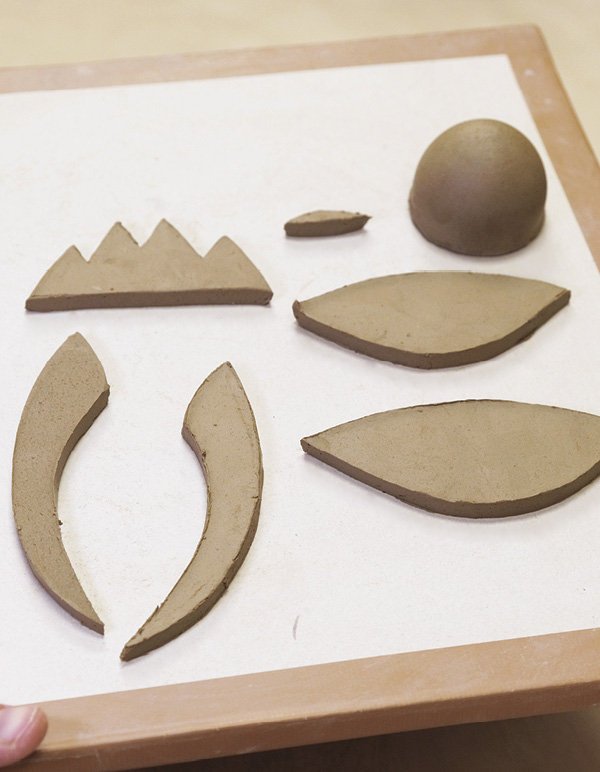 3 Cut one pair of wings, one set of tail feathers, and two lozenges from a slab.