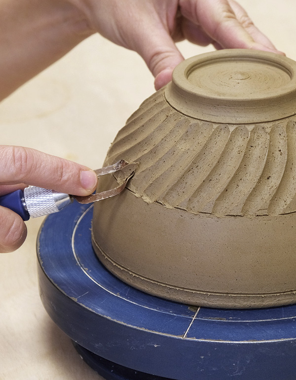 4 Using a fluting tool, carve texture into the trimmed bowl.