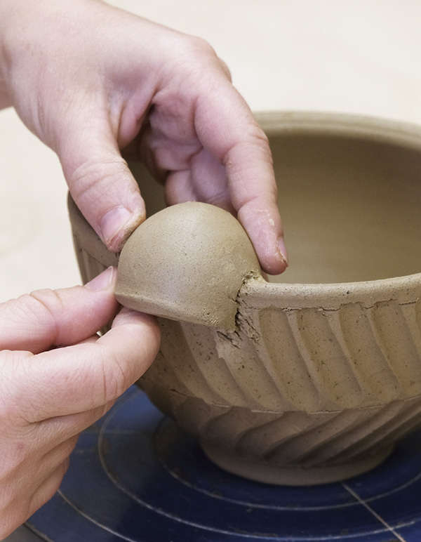 5 Cut notches into the side of a small dome to slide over the rim of the bowl.